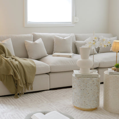 Millie 4-Seater Fabric Modular Sofa Light Beige with clean lines, deep seating, and removable cushions, showcased in a modern interior with a close-up of a white pillow on a couch.
