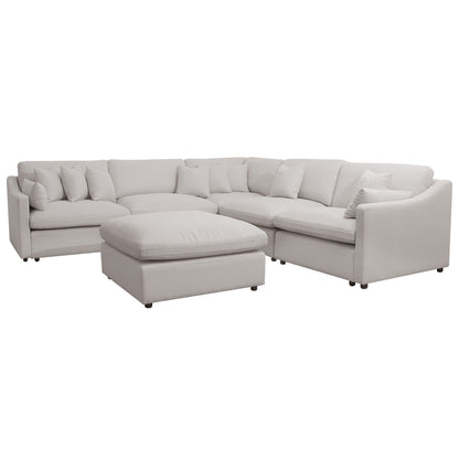 Millie 6-Seater Fabric Corner Chaise Sofa in Warm Light Grey, featuring plush cushions and a modular design, displayed with a white pillow on one of its deep, cozy seats.