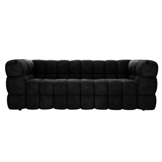 Norah 3 Seater Velvet Sofa in Black, featuring a modern, low-profile design with chunky, tufted block cushions forming the seat, back, and arms in a continuous, modular style.