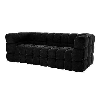 Norah 3 Seater Velvet Sofa in Black features a quilted, block-like design with oversized square cushion modules forming the seat, back, and arms, creating a modern, low-profile silhouette.