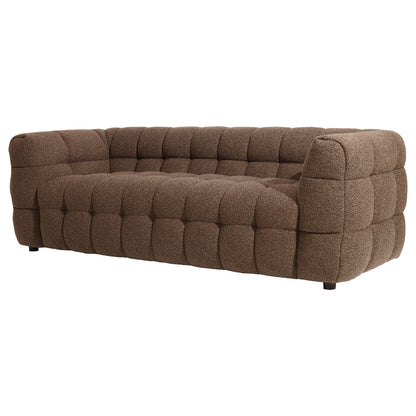 Norah 3 Seater Boucle Sofa in Brown features a block-like design with deep quilted tufting, textured brown upholstery, and short hidden legs, offering modern comfort and elegance.