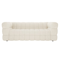 Norah 3 Seater Boucle Sofa in Cream White features a low-profile design with chunky, deeply tufted cushions. Its quilt-like bouclé upholstery enhances comfort and elegance, ideal for modern interiors.