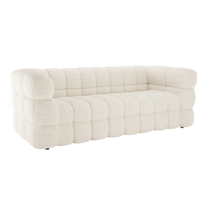 Norah 3 Seater Boucle Sofa in Cream White features off-white boucle fabric with oversized, rounded grid-like tufting on seat, back, and arms, offering a plush, modular appearance.