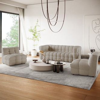 Norah 5-Seater Boucle Sofa Set with Armless Chairs in Warm Beige features an L-shaped tufted design, complemented by matching lounge chairs and round coffee tables, creating a contemporary, inviting living space.