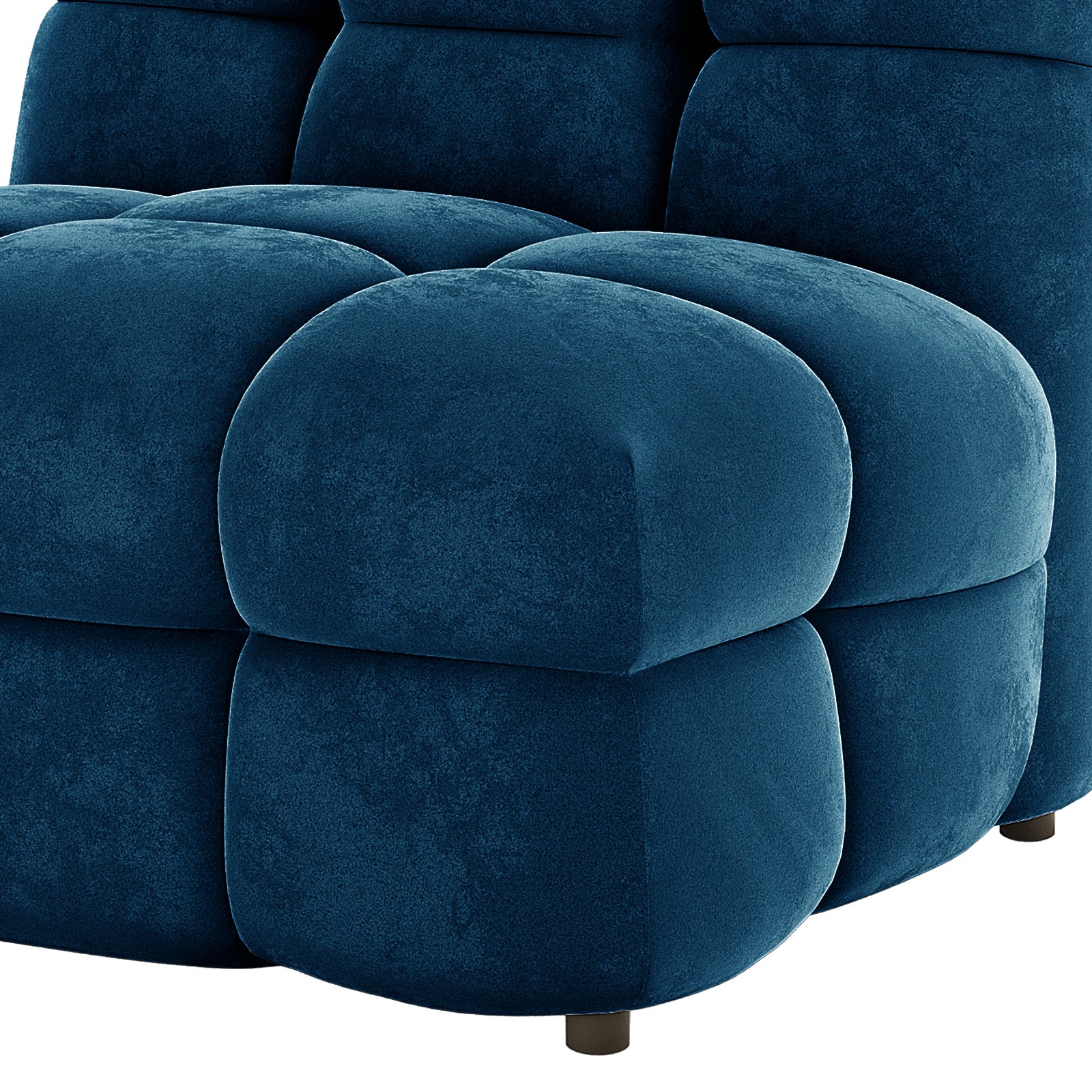 Close-up of the Norah 5 Seater Velvet Sofa Set with Ottoman in Blue, showcasing its tufted, cushiony seat and back panels, deep blue velvet-like upholstery, and a short, round black leg.