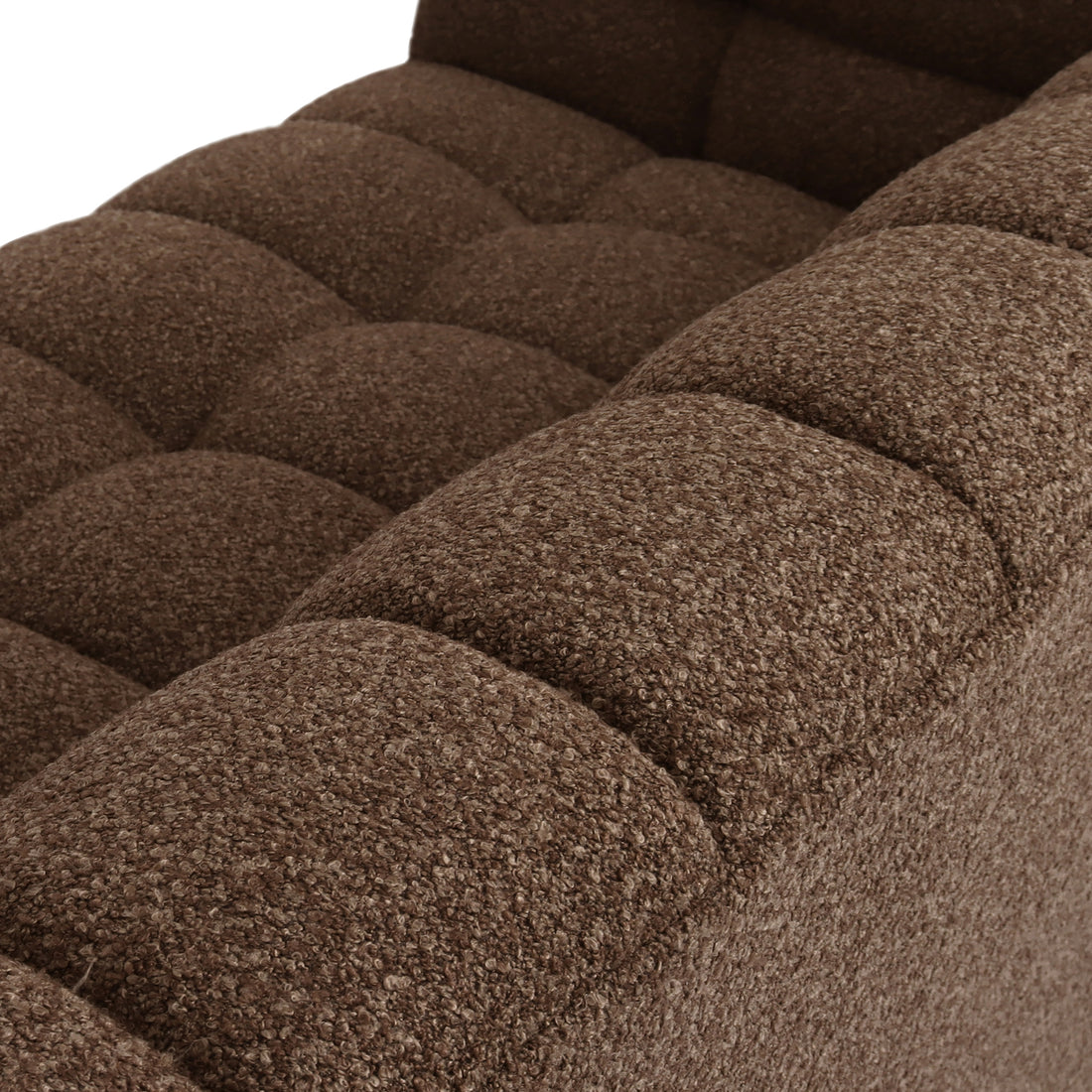 Close-up of the Norah 5 Seater Boucle Sofa Set With Ottoman in Brown, highlighting the armrest and seat cushion with loop-pile fabric and deep tufting, embodying modern elegance and plush comfort.