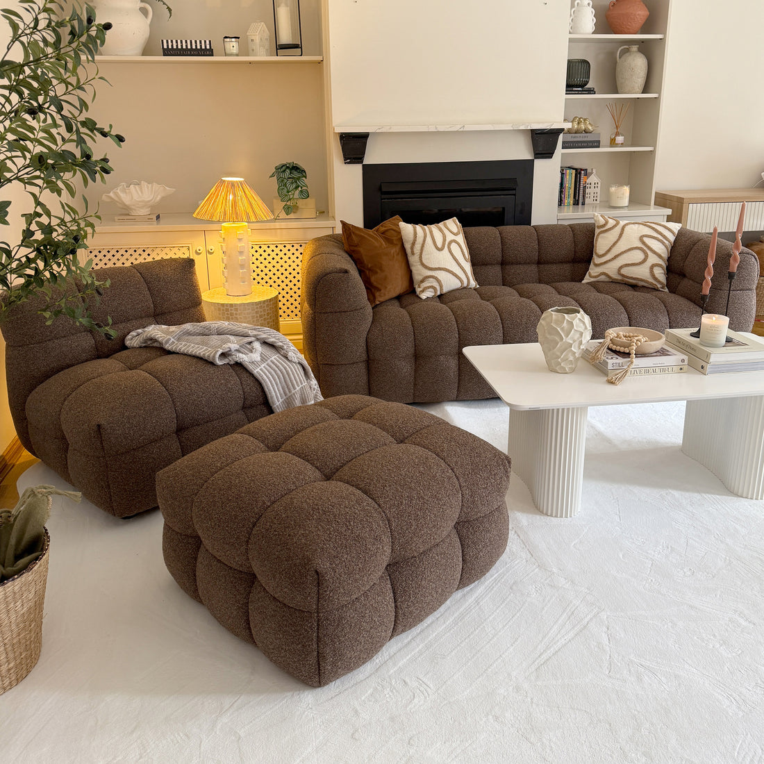 Norah 5 Seater Boucle Sofa Set With Ottoman in Brown, featuring tufted design, paired with a white coffee table and decorative items, set in a cozy, neutral-toned living room corner.