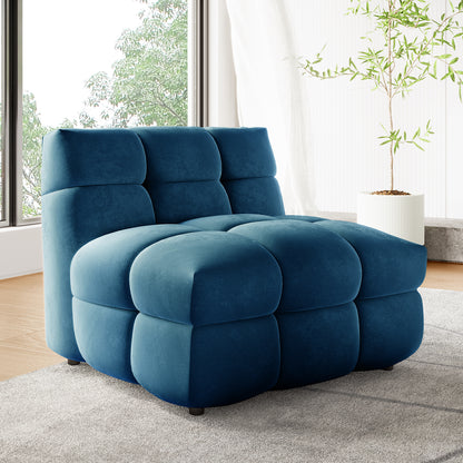 Norah Single Seater Tufted Velvet Sofa in Blue, showcasing plush, oversized tufted cubes, set on a light gray rug. Framed by a window with greenery and a potted plant, highlighting its modern, minimalist appeal.