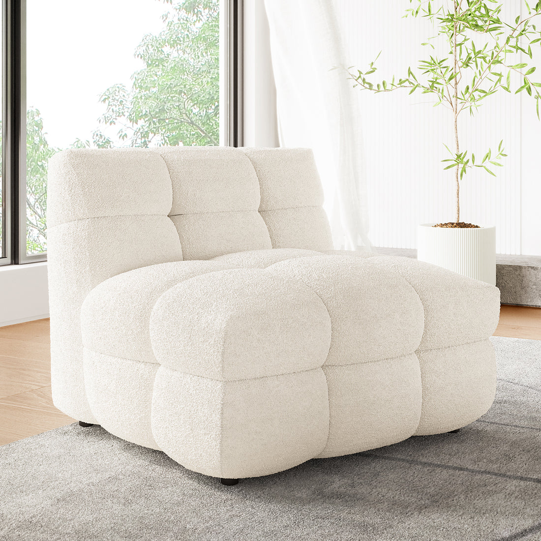 Norah Single Seater Boucle Sofa in Cream White with tufted, grid-patterned cushions, sits on a grey rug in a modern living space, accompanied by a tall potted plant.
