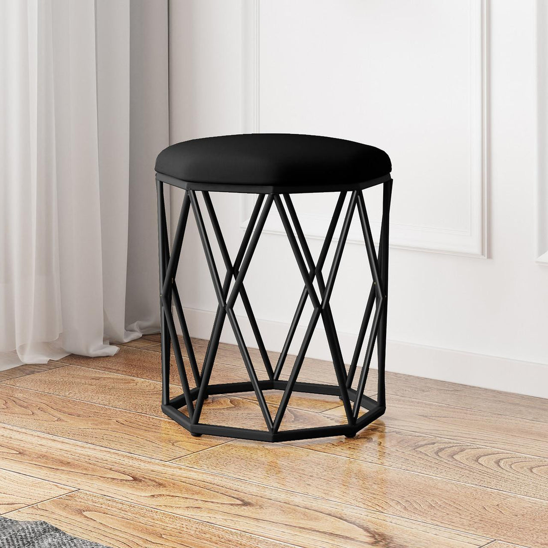 Paisley Velvet Round Accent Stool with Cushion in Black features a geometric-style black metal wireframe base and a plush, round, black upholstered seat, perfect for adding elegance to any room.