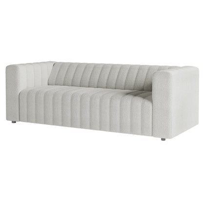 Parisa 3 Seater Tufted Boucle Sofa features a close-up of its plush boucle fabric with elegant tufted detailing, showcasing the sofa's luxurious texture and modern low-rise design.