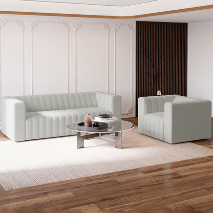 Parisa 4 Seater Tufted Boucle Sofa Set in Light Grey features elegant vertical channel-tufting and a low-rise design, complemented by a matching armchair, enhancing the contemporary living-room setup.