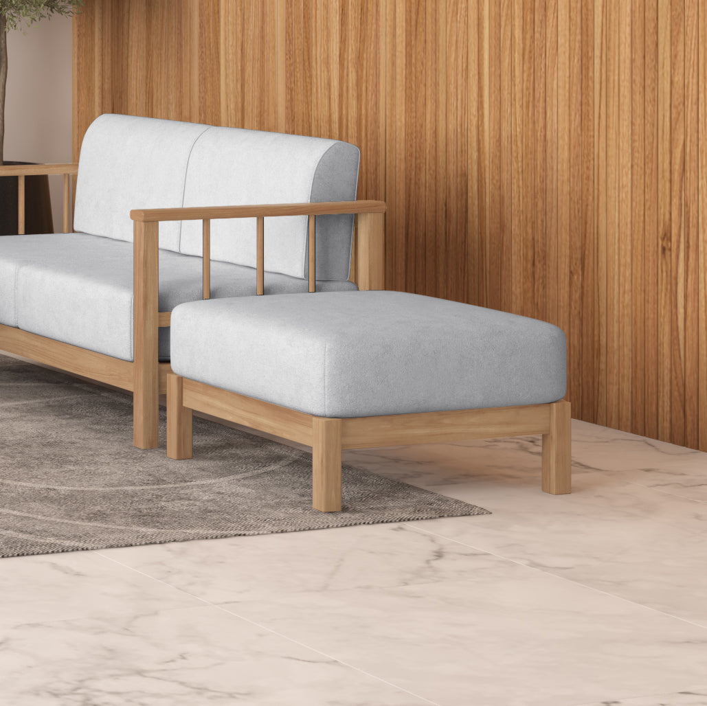 Raylai Hardwood American Oak Ottoman in Grey Fabric, featuring a minimalist design with a light gray upholstered cushion on a sturdy wooden frame, set on a neutral woven rug.