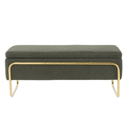 Riane Boucle Storage Ottoman in Green, featuring a muted olive/gray boucle fabric, rectangular design, and tubular metal frame with polished brass legs, offering both style and hidden storage functionality.