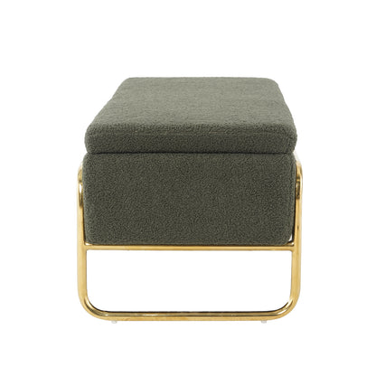 Riane Boucle Storage Ottoman in Green, featuring an olive-green boucle cushion atop a polished brass-tone metal base. The ottoman offers hidden storage, combining modern elegance with practical functionality.