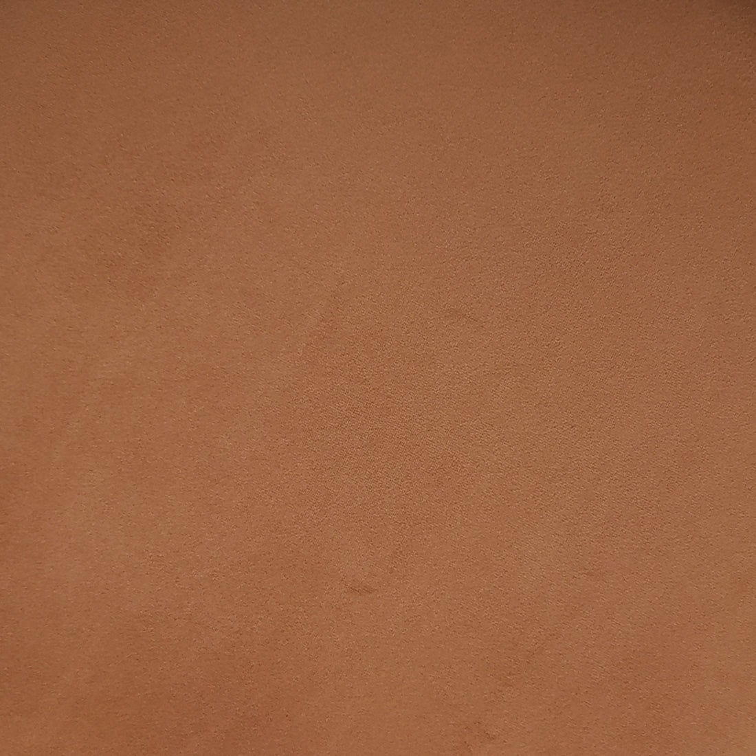 Sadi Velvet Fabric Round Mushroom Ottoman - Burnt Orange, showcasing a soft, slightly mottled brown-orange surface resembling suede. The ottoman's plush texture and modern design add stylish comfort to any living space.