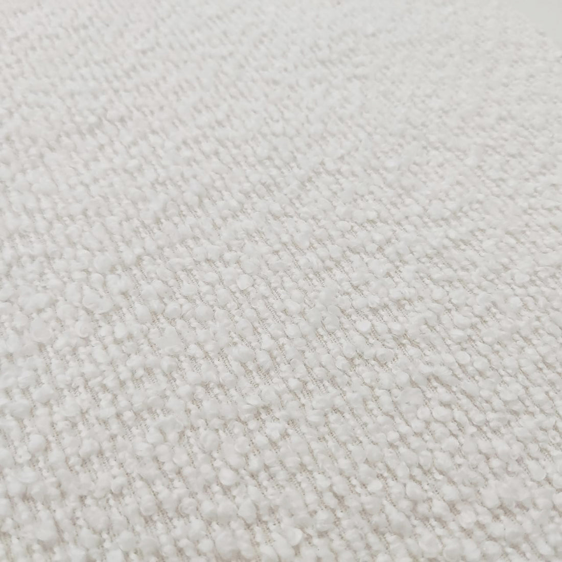 Close-up of the Sadi Bouclé Fabric Round Mushroom Ottoman in Eggshell White, showcasing its textured loop-pile surface and soft, rounded modern design, highlighting the plush and stylish bouclé fabric.