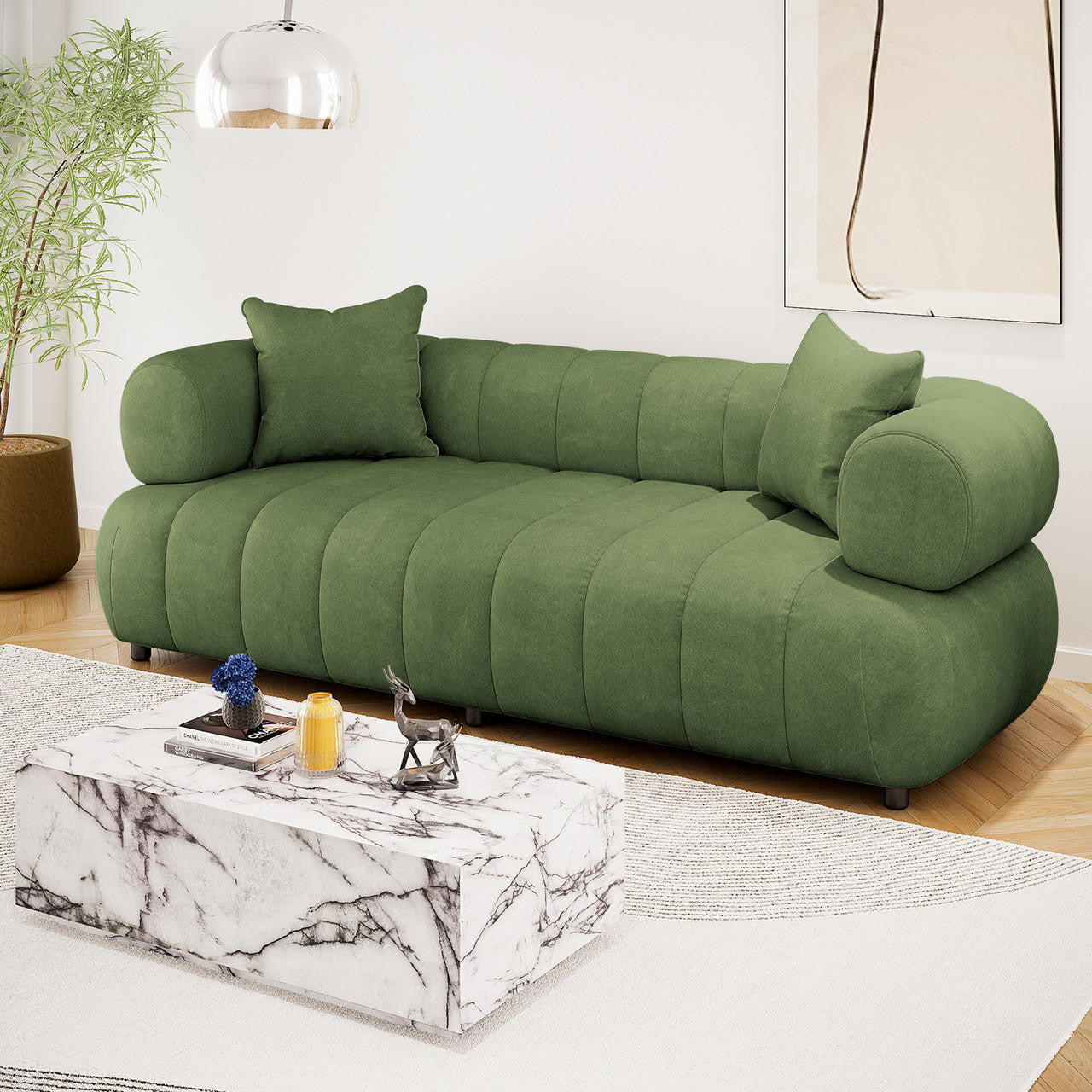 Samira 3 Seater Velvet Sofa in Prasinous Green, featuring plush, rounded cushioning with matching pillows, elegantly styled in a modern living room with a marble coffee table and abstract wall art.