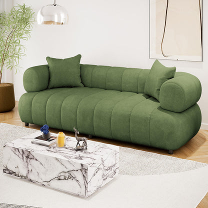 Samira 3 Seater Velvet Sofa in Prasinous Green, featuring plush, rounded cushioning with matching pillows, elegantly styled in a modern living room with a marble coffee table and abstract wall art.