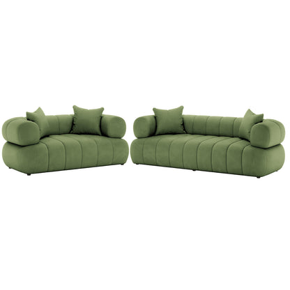 Samira 5 Seater Velvet Sofa Set in Prasinous Green features olive-green modular sofas with low, tufted profiles, rounded arms, and matching throw pillows, offering a luxurious, spacious seating arrangement.