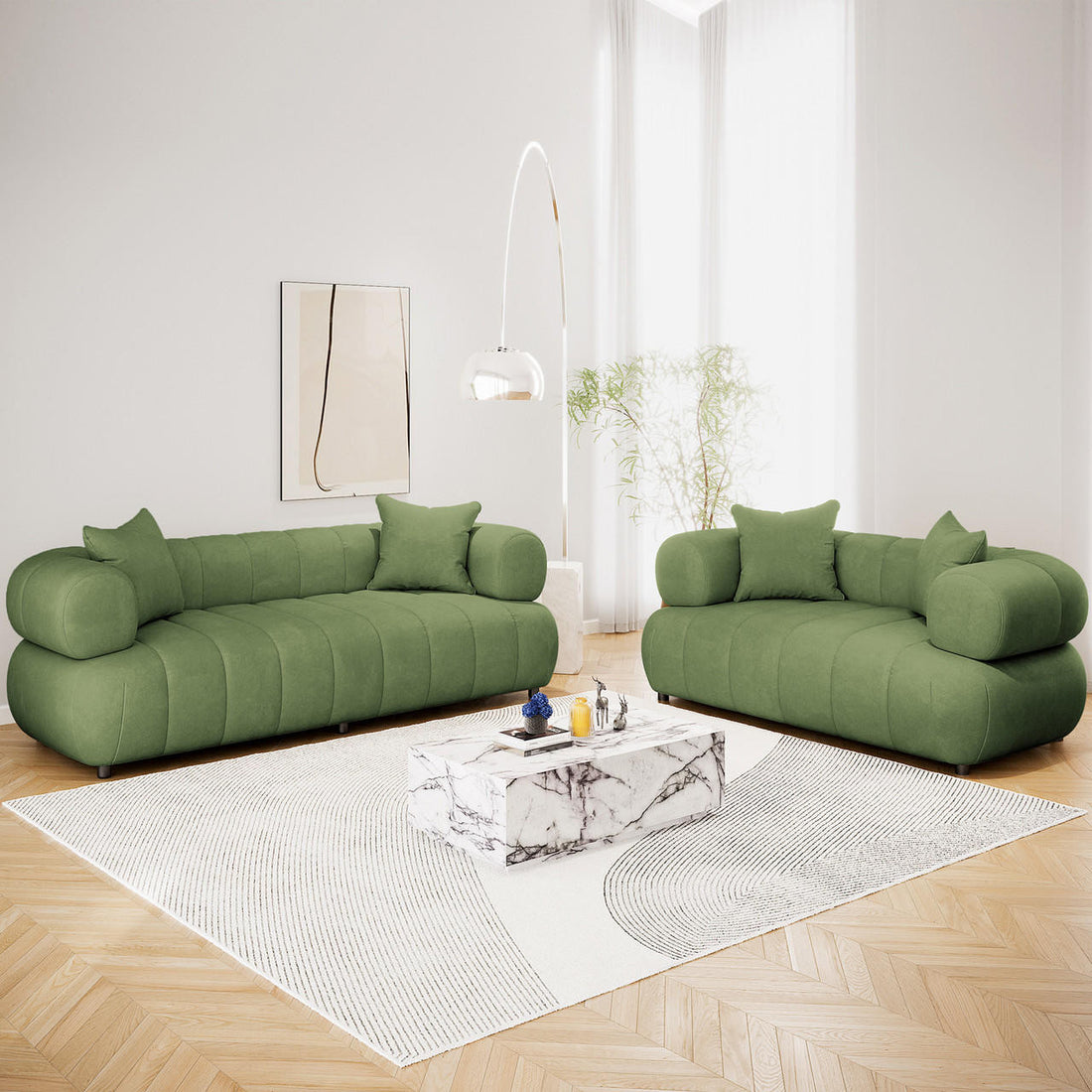 Samira 5 Seater Velvet Sofa Set in Prasinous Green features plush, rounded sofas with matching throw pillows, centered in a minimalist living room, exuding elegance and comfort around a marble coffee table.