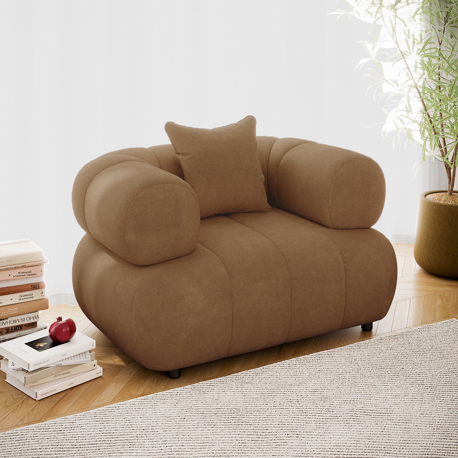 Samira Single Seater Velvet Sofa in Camel Brown, showcasing plush velvet upholstery and a single throw pillow, set in an elegant indoor space with a nearby potted plant enhancing its luxury appeal.