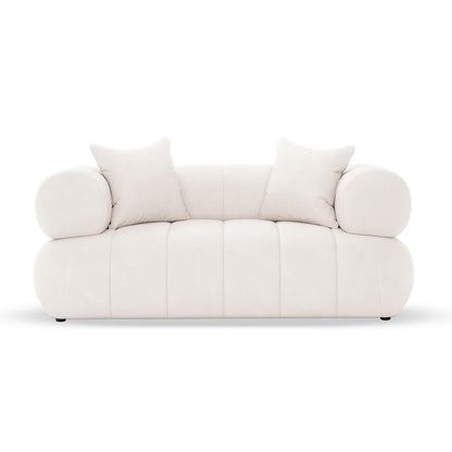 Samira 6 Seater Velvet Sofa Set in Cream, featuring a modern low-profile design with two square throw pillows and cylindrical bolster cushions, offers an inviting and elegant seating arrangement.