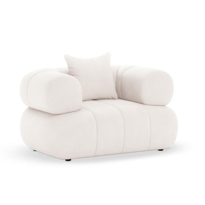 Samira 6 Seater Velvet Sofa Set in Cream: Features a plush, modern-style armchair with an off-white fabric, low rounded profile, oversized cylindrical arms, and a matching throw pillow against a plain background.