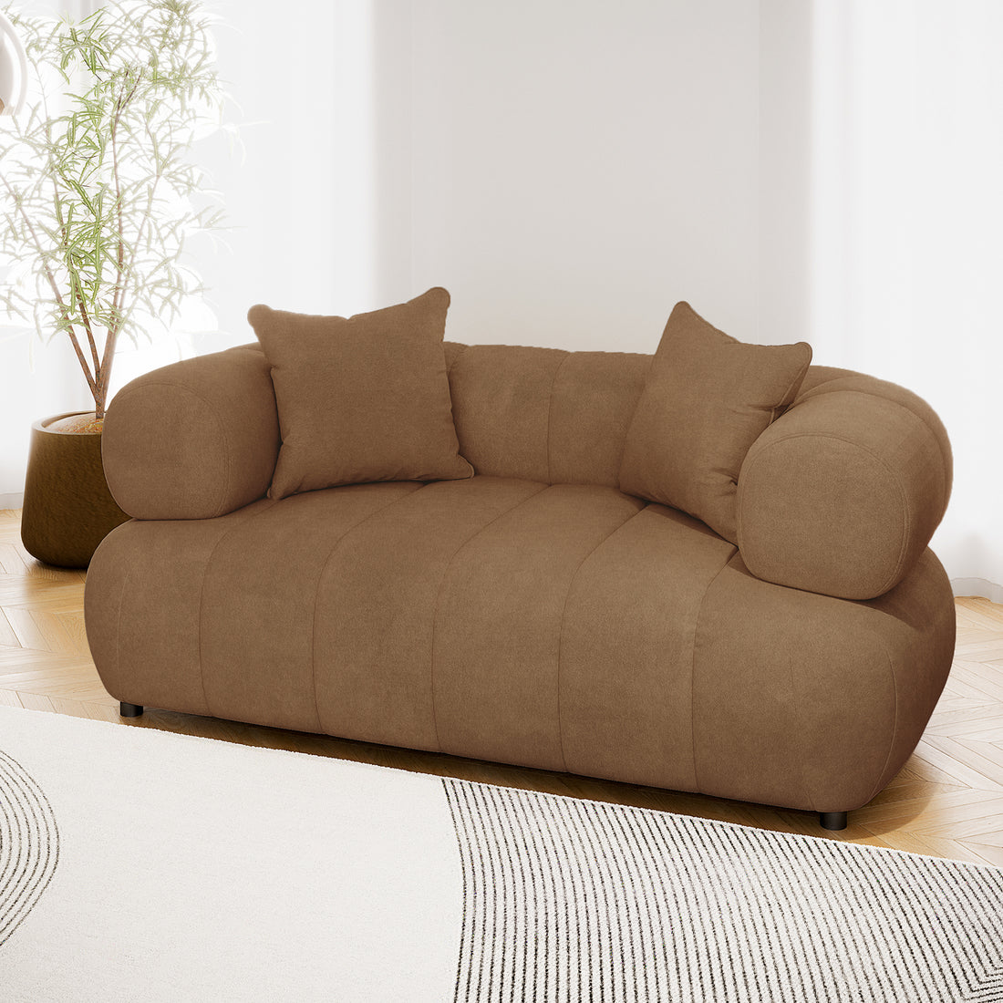 Samira 2 Seater Velvet Sofa in Camel Brown, showcasing its luxurious velvet fabric, plush cushioning, and elegant design, with visible matching pillows enhancing comfort and style.