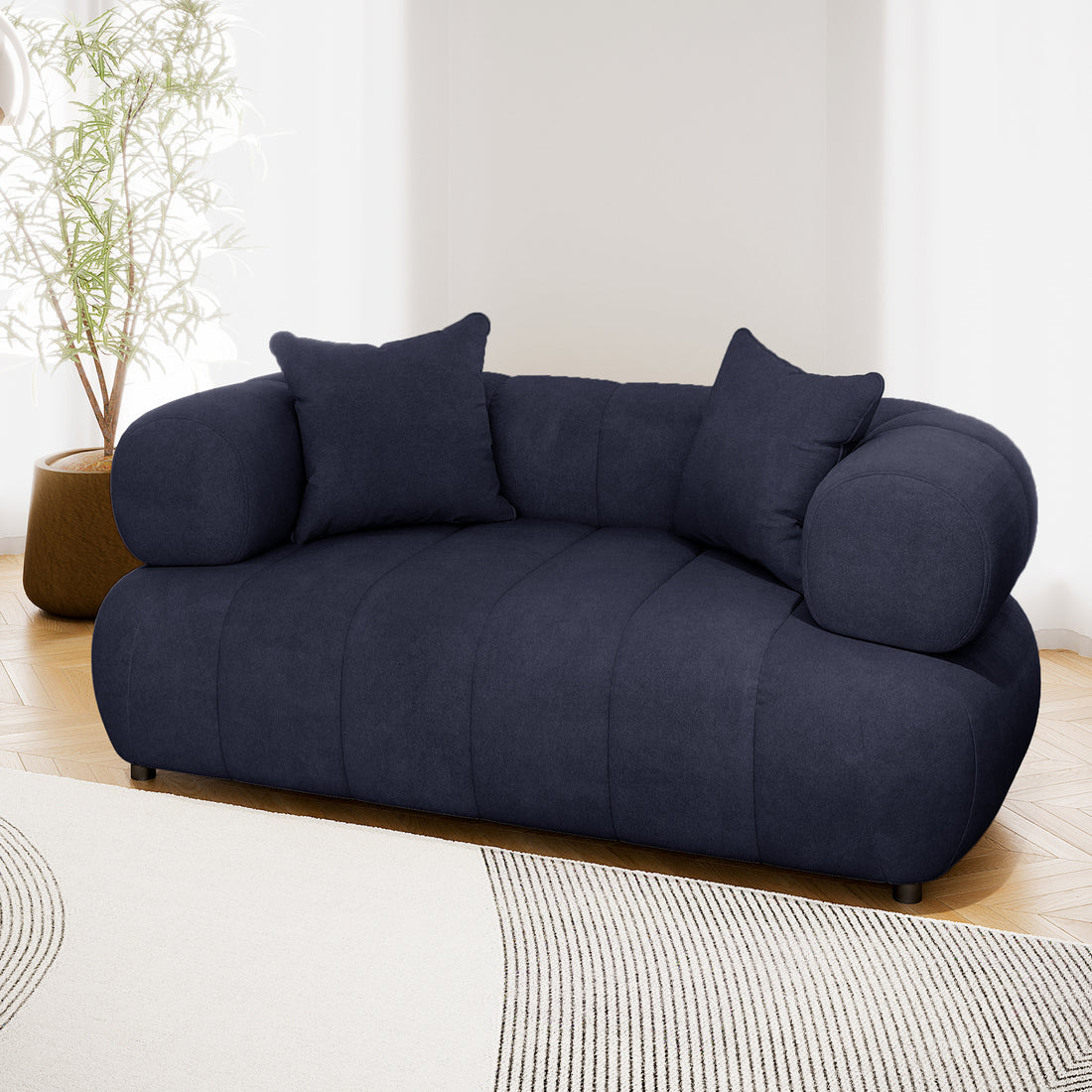 Samira 2 Seater Velvet Sofa in Navy Blue, showcasing plush velvet upholstery with high-density foam padding and solid wood frame, set elegantly in a modern indoor setting.
