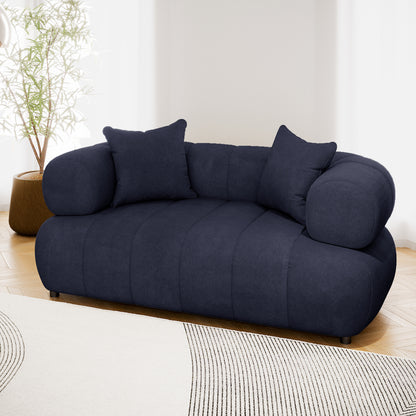 Samira 2 Seater Velvet Sofa in Navy Blue, showcasing plush velvet upholstery with high-density foam padding and solid wood frame, set elegantly in a modern indoor setting.