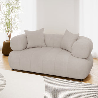 Samira 2 Seater Velvet Sofa in Warm Beige, showcasing plush velvet upholstery, two matching pillows, and a solid wood frame, perfect for modern elegance and comfort in any living space.