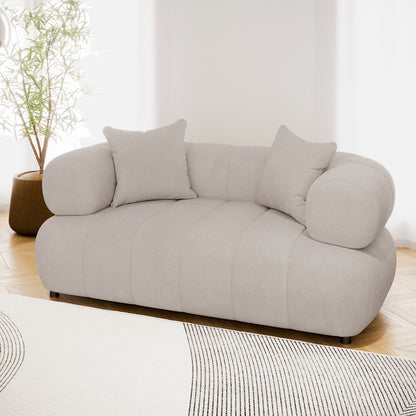 Samira 2 Seater Velvet Sofa in Warm Beige, showcasing plush velvet upholstery, two matching pillows, and a solid wood frame, perfect for modern elegance and comfort in any living space.