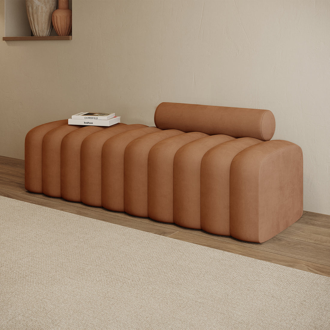 Sasa Velvet Tufted Fabric Bench with Backrest Burnt Orange, featuring rounded ribbed sections, cylindrical bolster, and two books. Bench set against light wood floor and textured off-white wall.