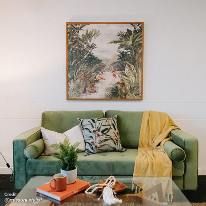 Sollia 3-Seater Velvet Sofa in Jade Green, elegantly styled with plush velvet upholstery, positioned beside a coffee mug, book, and decorative plant, enhancing a sophisticated living space.