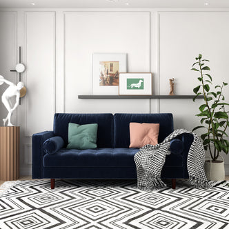 Sollia 3-Seater Velvet Sofa - Navy Blue: A plush navy blue velvet couch with sleek lines, featuring two matching round bolster pillows, perfectly suited for elegant and modern living room interiors.
