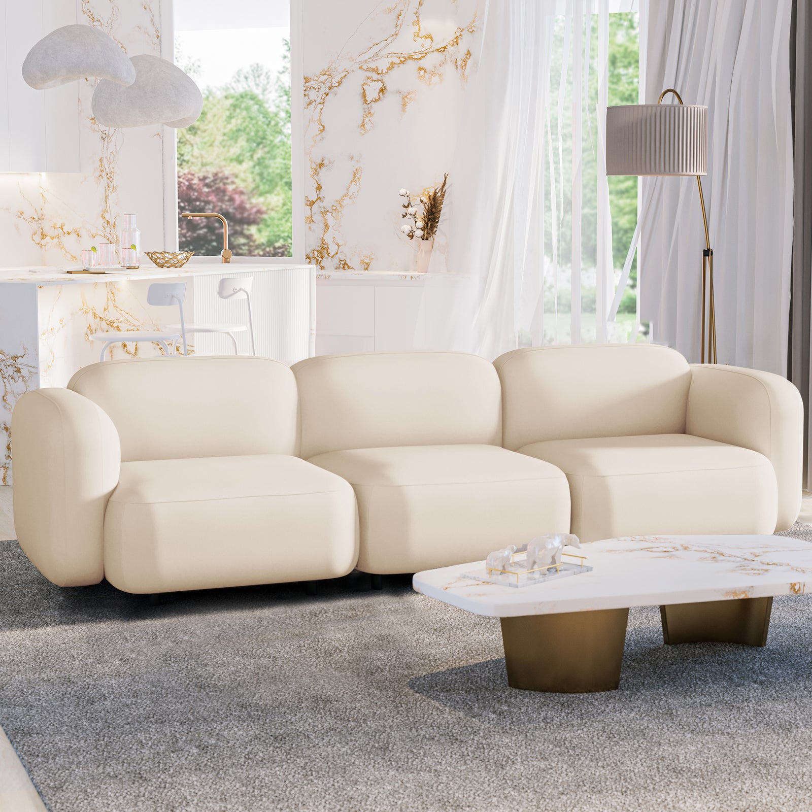 Soraya 3 Seater Modular Velvet Sofa Set - Cream White, elegantly upholstered in plush velvet, shown in a modern living room setting with a white couch, marble table, and decorative polar bear figurine.