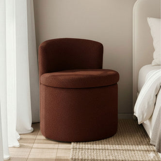 Sorra Boucle Swivel Storage Accent Chair in Rust Brown on a woven rug, featuring a low curved backrest, highlighting its elegant bouclé upholstery and compact hidden storage design.