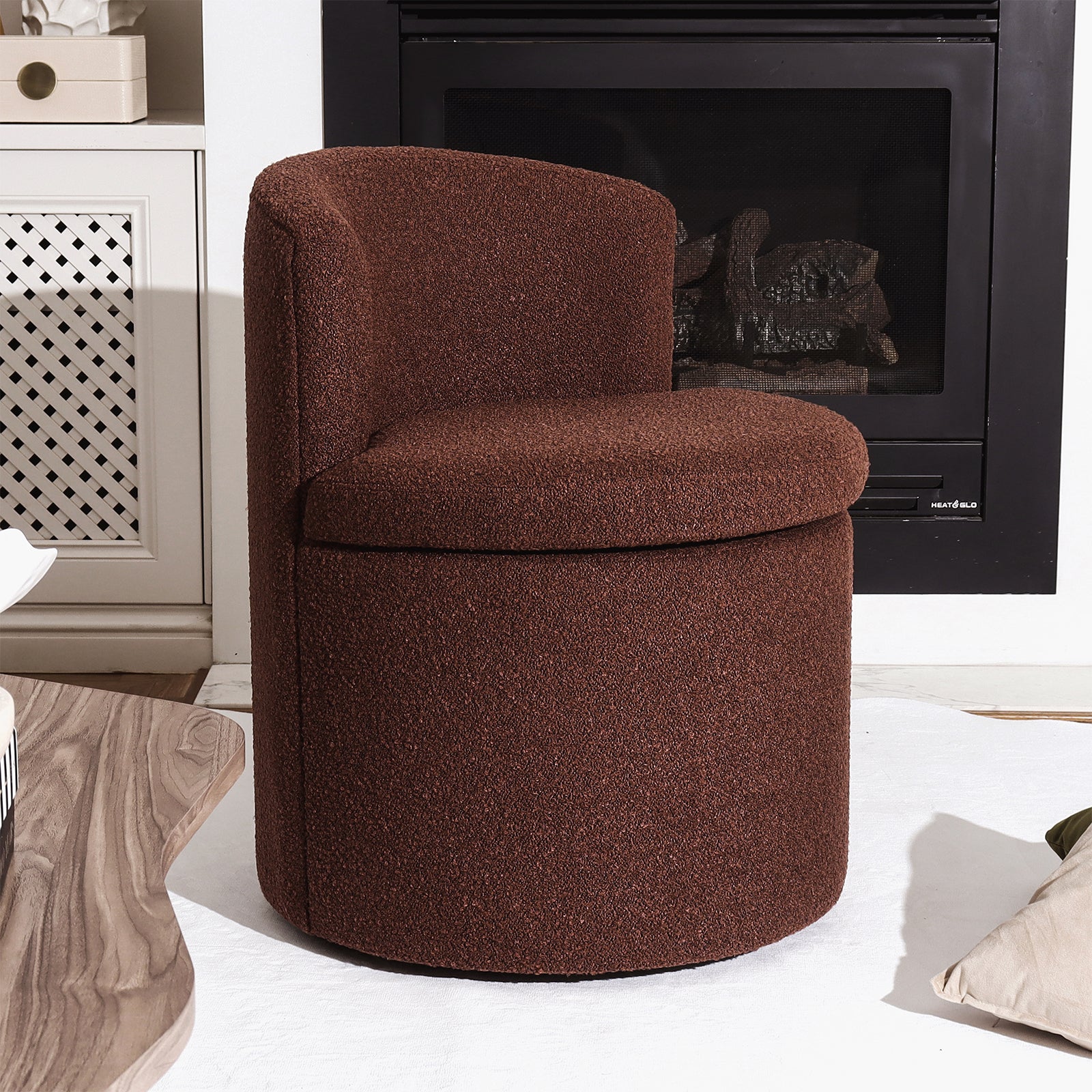 Sorra Boucle Swivel Storage Accent Chair in Rust Brown, upholstered in boucle fabric with hidden storage, positioned near a black-trimmed fireplace and light wood coffee table on a light rug.