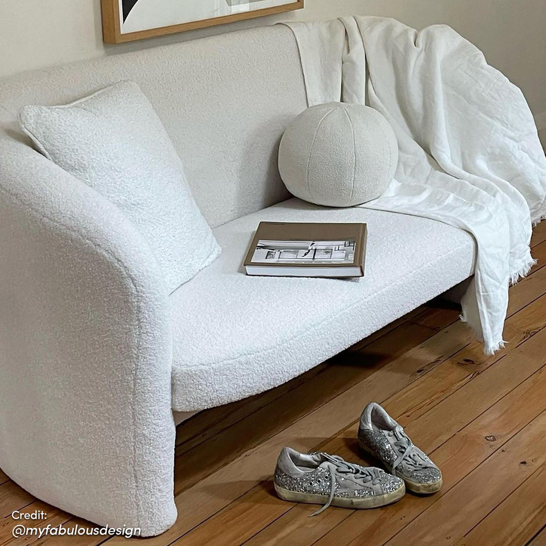 Tasha Boucle 2 Seater Sofa Cream White with boucle upholstery, curved arms, and solid wood frame, displayed in a living room setting.