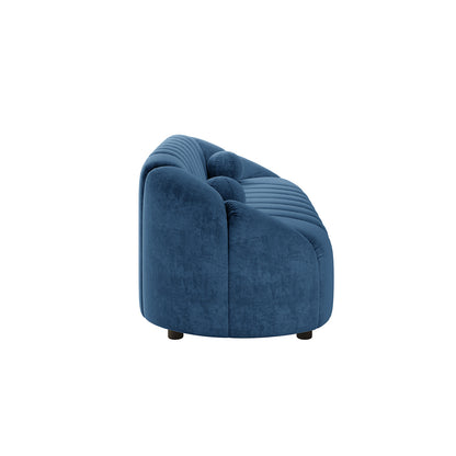 Trina 3 Seater Tufted Velvet Sofa in Blue with a curved silhouette, deep blue velvet upholstery, channel tufting on back and seat, and short, rounded black legs, offering modern elegance and comfort.