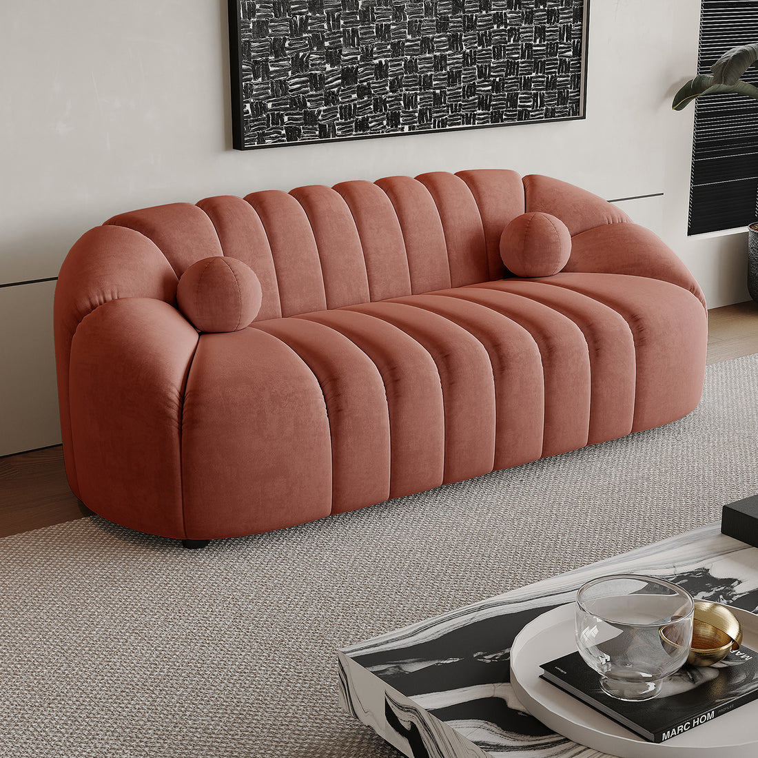 The Trina 3 Seater Tufted Velvet Sofa in Blush features a softly rounded, channel-tufted design with matching bolster pillows, offering a sophisticated and comfortable seating option for modern living spaces.