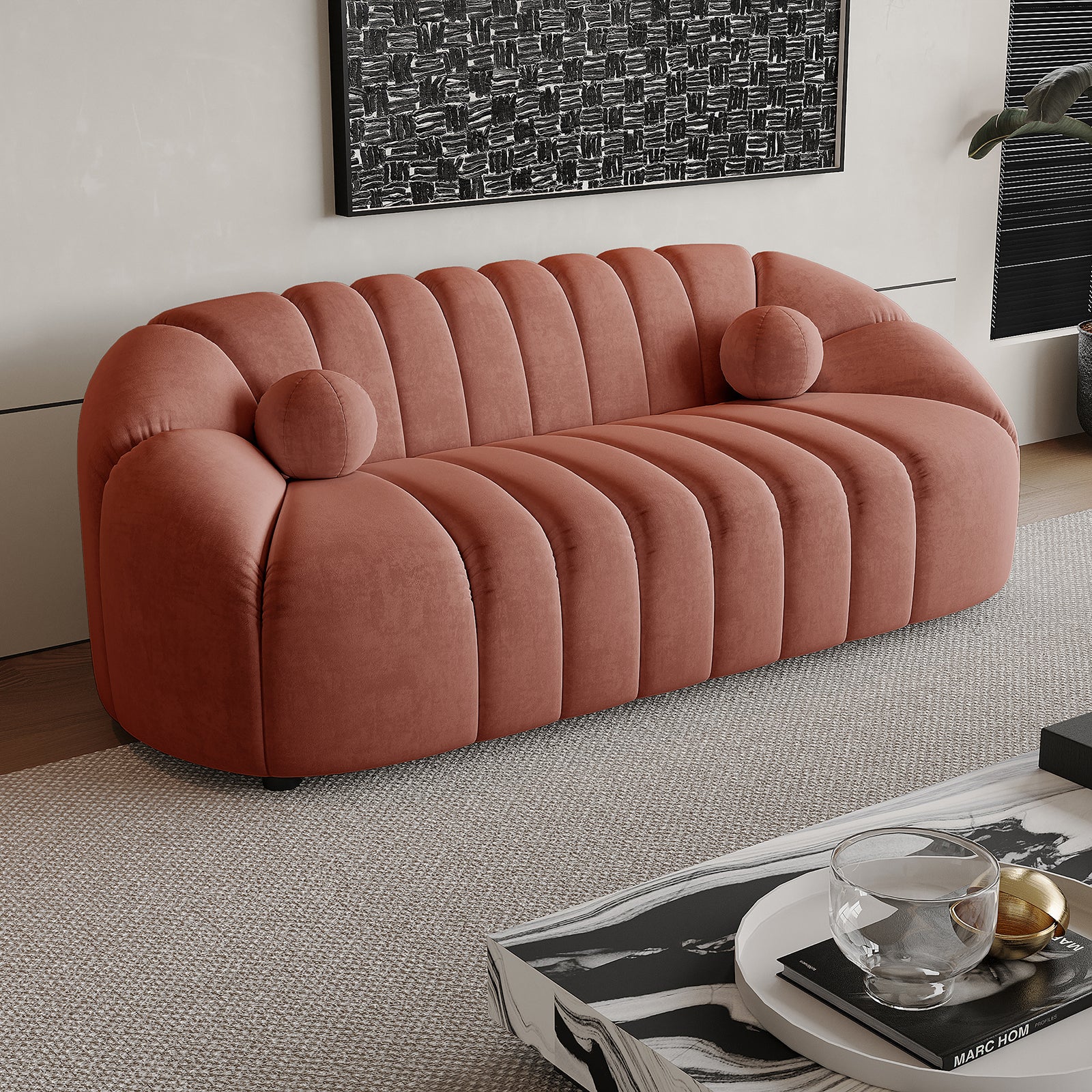 The Trina 3 Seater Tufted Velvet Sofa in Blush features a softly rounded, channel-tufted design with matching bolster pillows, offering a sophisticated and comfortable seating option for modern living spaces.
