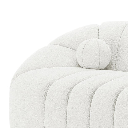 Trina 5 Seater Boucle Sofa Set with Pillows in Cream White features a close-up of its curved arm, upholstered in soft bouclé fabric, with a round bolster pillow against the channel-tufted back.