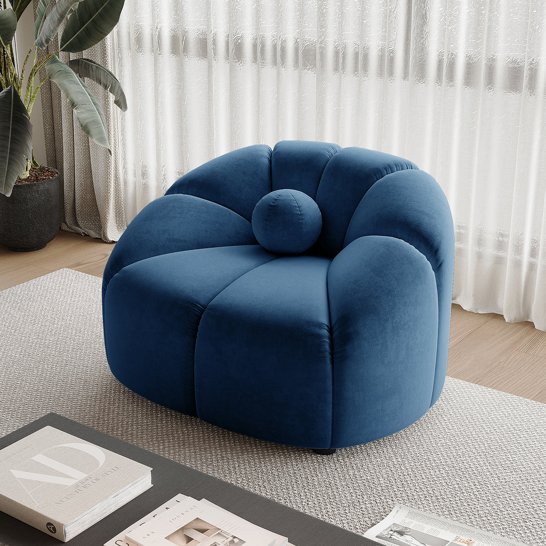 Trina Single Velvet Tufted Accent Chair in Blue, featuring a plush, rounded tufted back and matching bolster cushion, set on a textured rug near sheer curtains and a coffee table.