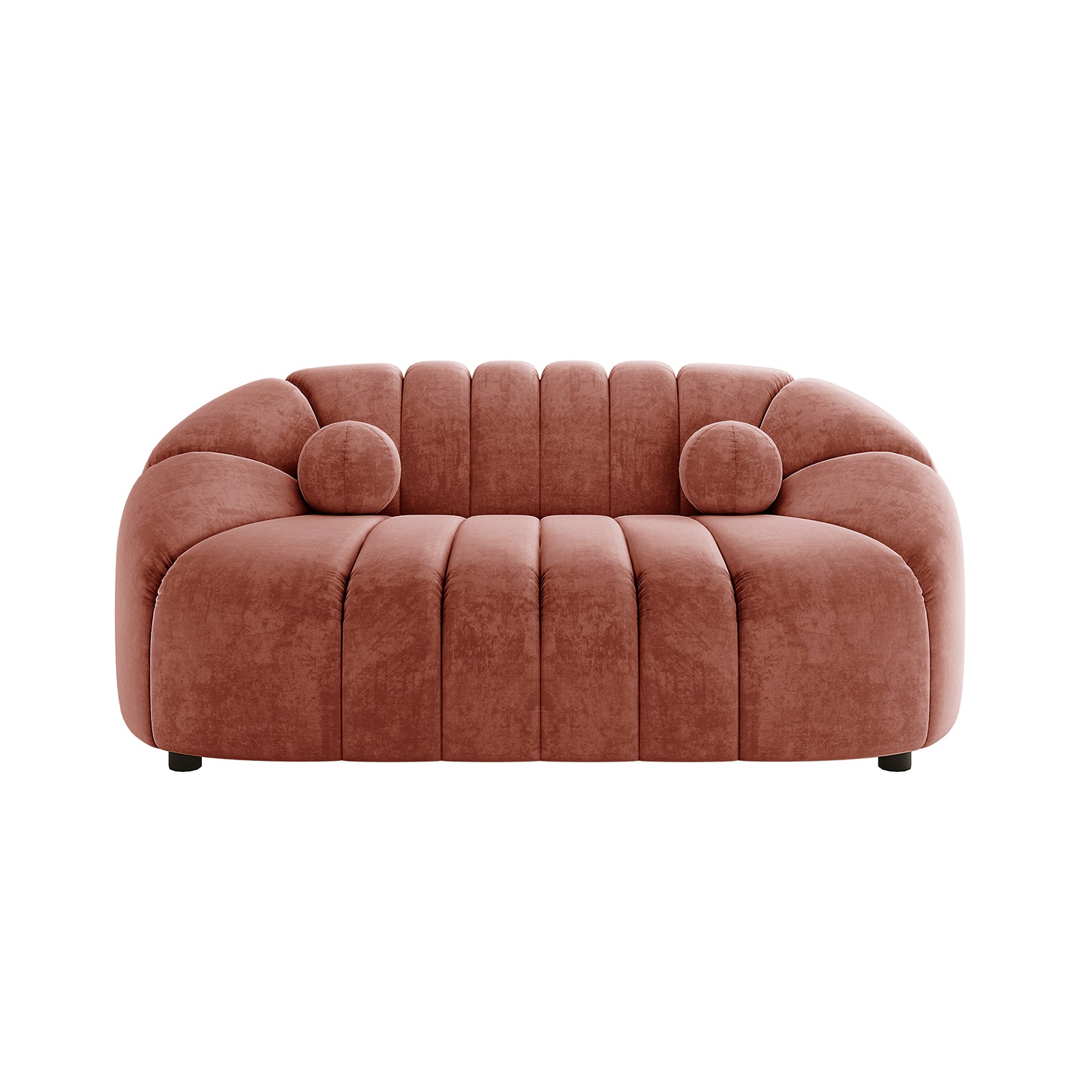 The Trina 2 Seater Tufted Curved Velvet Sofa in Blush showcases a sculptural, modern design with chunky channel-tufted padding and matching bolster pillows, ideal for compact, stylish living spaces.