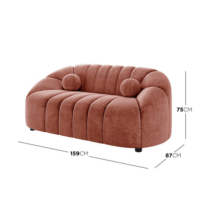 Trina 2 Seater Tufted Curved Velvet Sofa in Blush, featuring plush terracotta velvet, channel-tufted backrest, two round bolster cushions, and compact dimensions: 159 cm wide, 87 cm deep, 75 cm tall.
