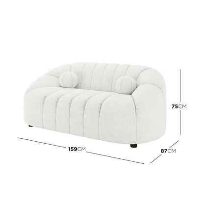 Trina 2 Seater Boucle Sofa with Pillows in Cream White features a soft, off-white bouclé fabric, rounded channel-stitched back and seat, and matching round bolster cushions, measuring 159cm wide, 87cm deep, 75cm tall.