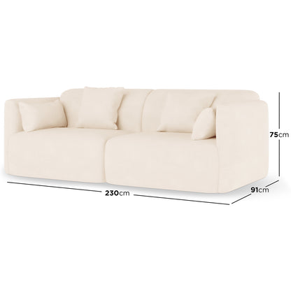 Vestalia 3 Seater Velvet Sofa in Cream White, featuring a low-profile design with light cream fabric, rounded edges, continuous seat cushion, and four loose back pillows, measuring 230cm wide.