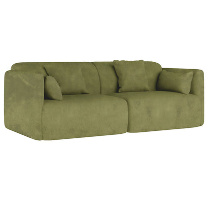 The Vestalia 4 Seater Velvet Sofa Set in Olive Green features two adjoining seating units with rounded edges and three matching loose cushions, showcasing a luxurious, modern design against a white background.